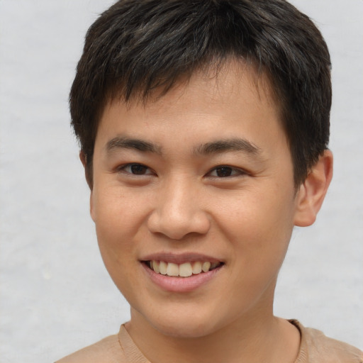 Joyful asian young-adult male with short  brown hair and brown eyes