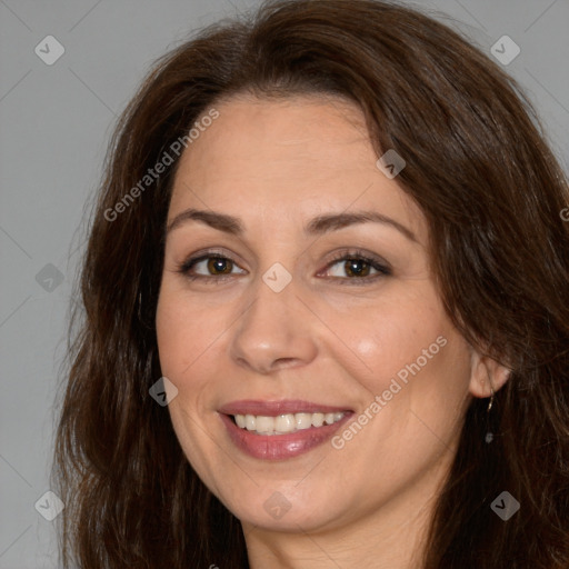 Joyful white adult female with long  brown hair and brown eyes