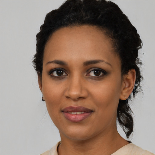 Joyful black young-adult female with medium  black hair and brown eyes
