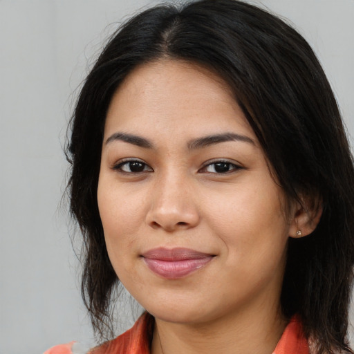 Joyful asian young-adult female with long  brown hair and brown eyes
