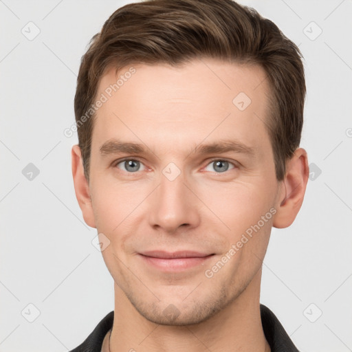 Joyful white young-adult male with short  brown hair and grey eyes