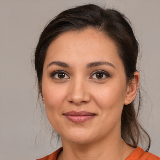 Joyful white young-adult female with medium  brown hair and brown eyes