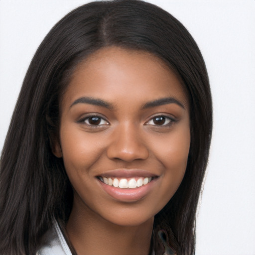 Joyful black young-adult female with long  brown hair and brown eyes