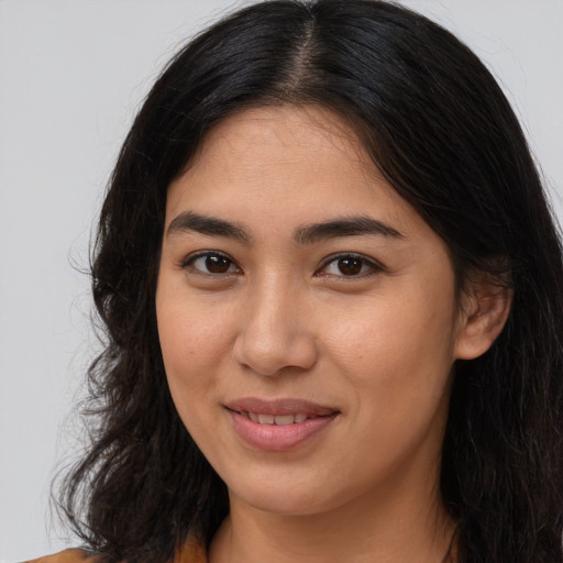 Joyful asian young-adult female with long  brown hair and brown eyes