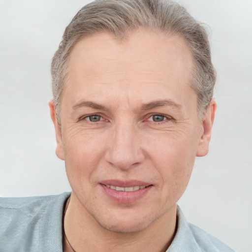 Joyful white adult male with short  brown hair and grey eyes