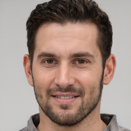 Joyful white young-adult male with short  brown hair and brown eyes