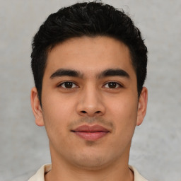 Joyful latino young-adult male with short  brown hair and brown eyes