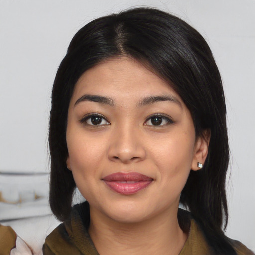 Joyful asian young-adult female with medium  black hair and brown eyes