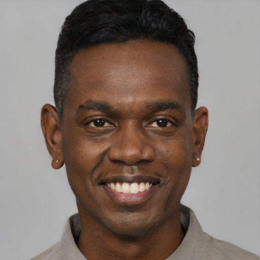Joyful black young-adult male with short  black hair and brown eyes