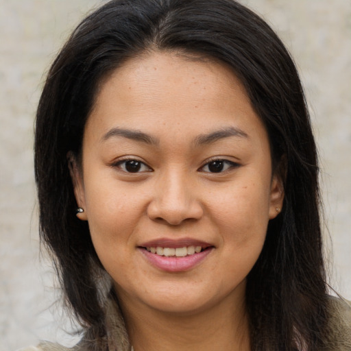 Joyful asian young-adult female with long  brown hair and brown eyes