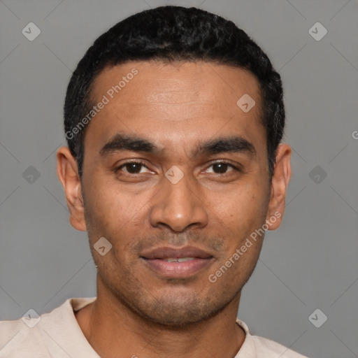 Joyful latino young-adult male with short  black hair and brown eyes