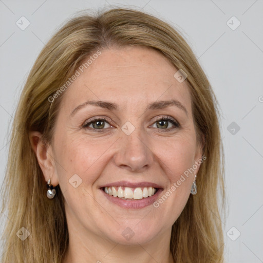 Joyful white adult female with long  brown hair and green eyes