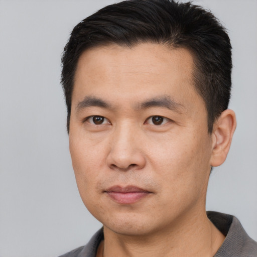 Neutral asian young-adult male with short  brown hair and brown eyes