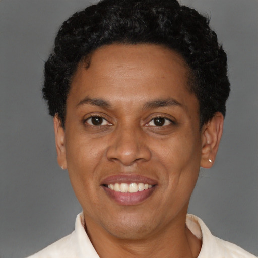 Joyful black adult female with short  brown hair and brown eyes