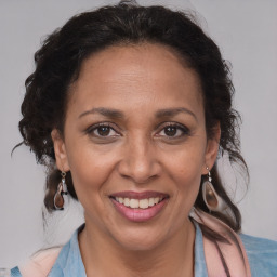 Joyful black adult female with medium  brown hair and brown eyes