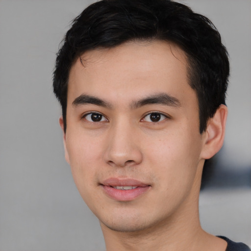Joyful asian young-adult male with short  black hair and brown eyes