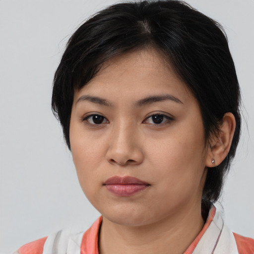 Joyful white young-adult female with medium  brown hair and brown eyes