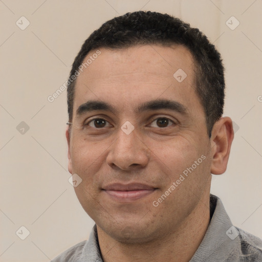 Joyful white young-adult male with short  black hair and brown eyes