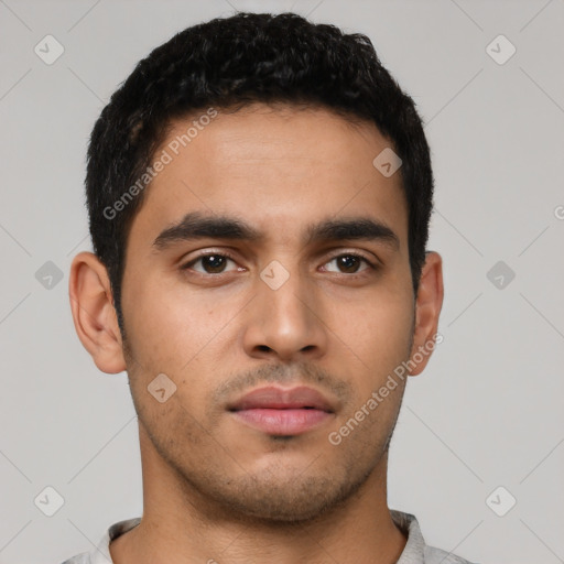 Neutral latino young-adult male with short  black hair and brown eyes