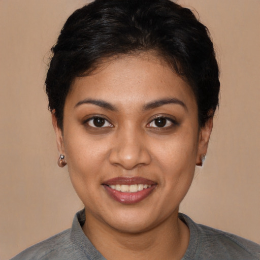 Joyful latino young-adult female with short  brown hair and brown eyes