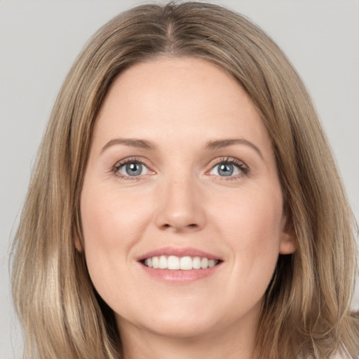 Joyful white young-adult female with long  brown hair and grey eyes