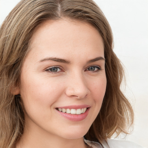 Joyful white young-adult female with long  brown hair and green eyes