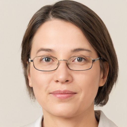 Joyful white adult female with medium  brown hair and grey eyes