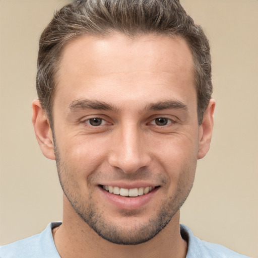 Joyful white young-adult male with short  brown hair and brown eyes