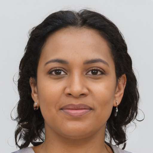 Joyful latino young-adult female with long  brown hair and brown eyes