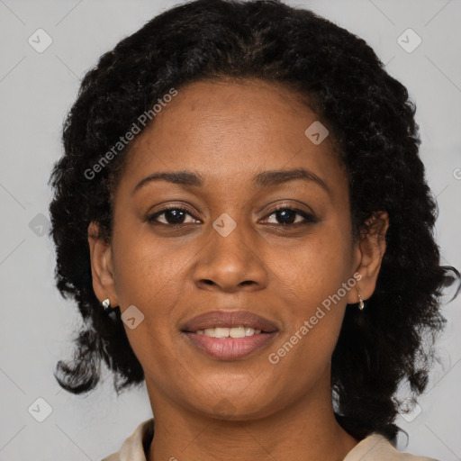 Joyful black adult female with medium  brown hair and brown eyes