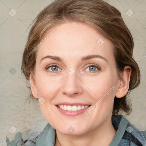 Joyful white adult female with medium  brown hair and blue eyes