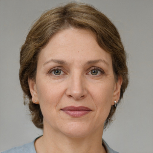 Joyful white adult female with medium  brown hair and grey eyes