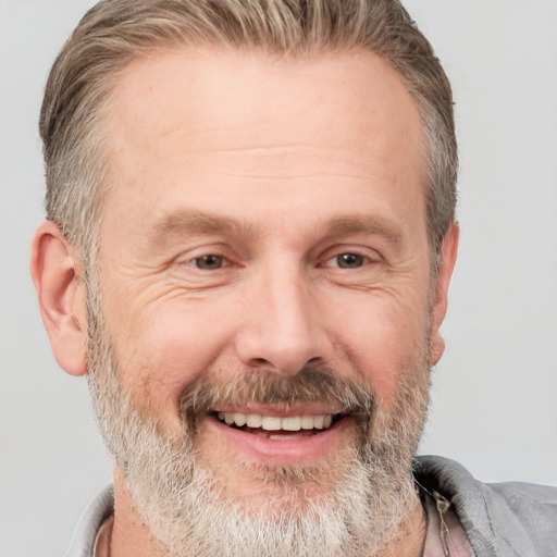 Joyful white middle-aged male with short  brown hair and grey eyes