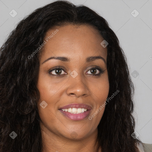 Joyful black young-adult female with long  brown hair and brown eyes