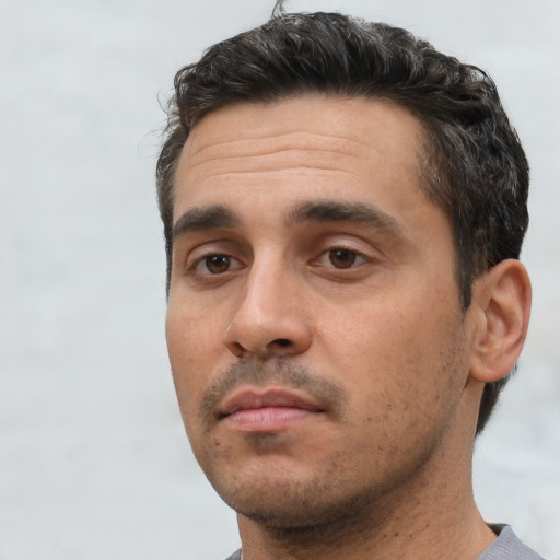 Neutral white young-adult male with short  black hair and brown eyes