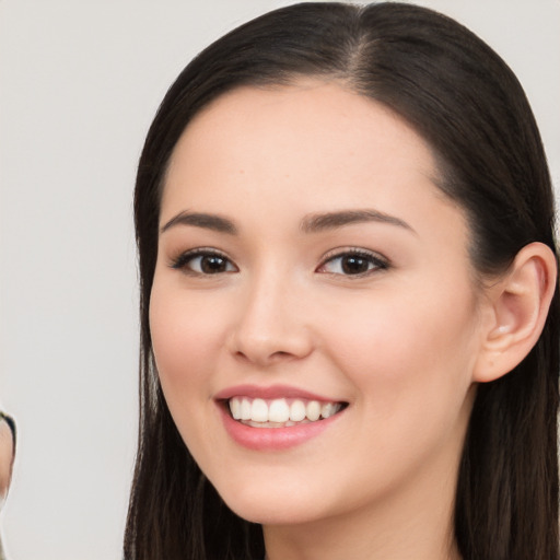 Joyful white young-adult female with long  black hair and brown eyes