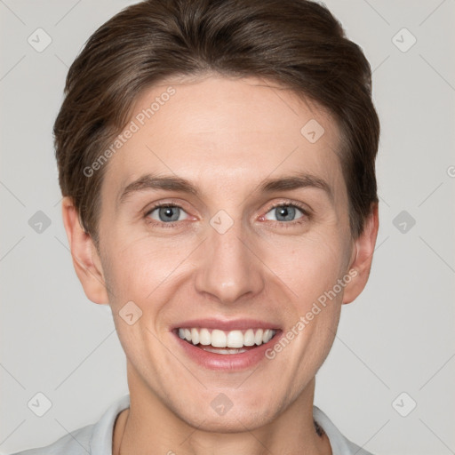 Joyful white young-adult male with short  brown hair and grey eyes