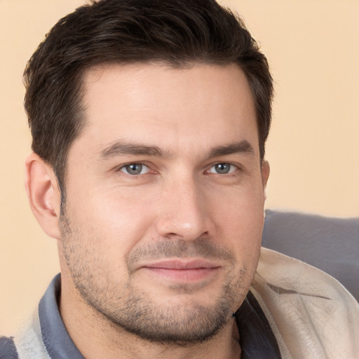 Joyful white young-adult male with short  brown hair and brown eyes