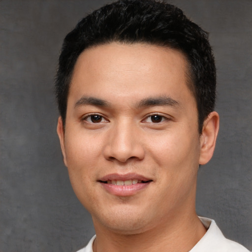 Joyful white young-adult male with short  black hair and brown eyes