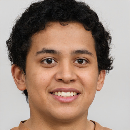 Joyful latino young-adult male with short  brown hair and brown eyes