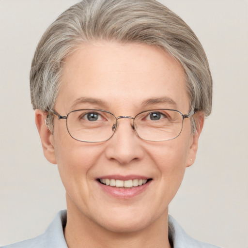 Joyful white middle-aged female with short  brown hair and blue eyes