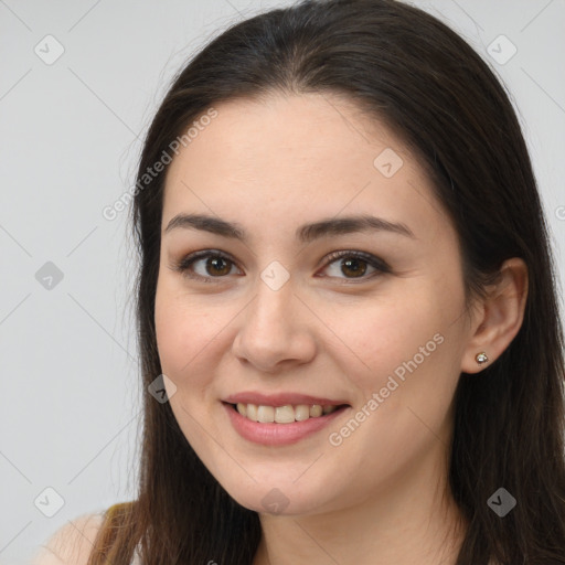 Joyful white young-adult female with long  brown hair and brown eyes