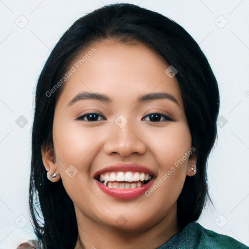 Joyful latino young-adult female with long  black hair and brown eyes