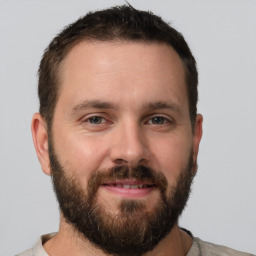 Joyful white adult male with short  brown hair and brown eyes