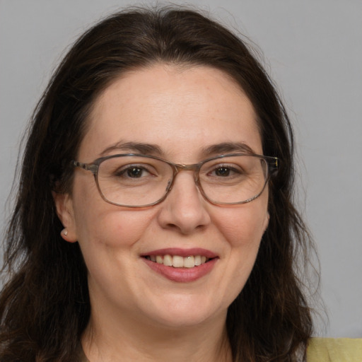 Joyful white adult female with medium  brown hair and brown eyes