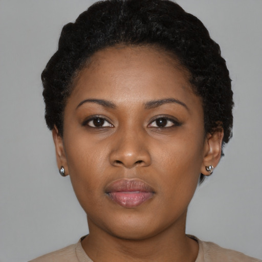 Joyful black young-adult female with short  black hair and brown eyes