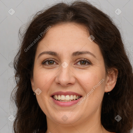 Joyful white adult female with long  brown hair and brown eyes