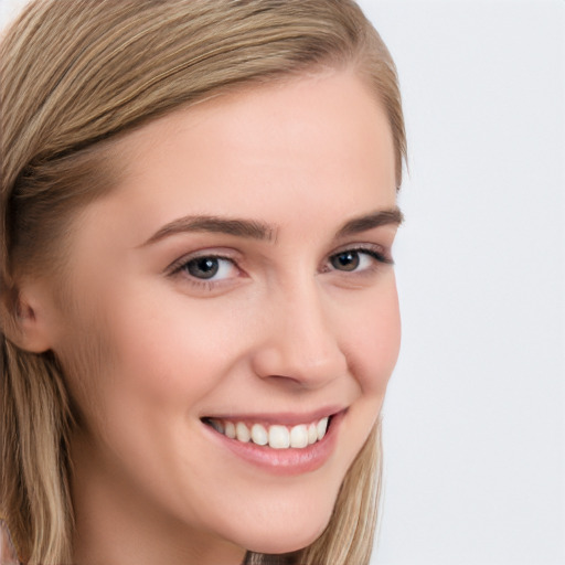 Joyful white young-adult female with long  brown hair and blue eyes