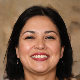 Joyful white adult female with medium  brown hair and brown eyes