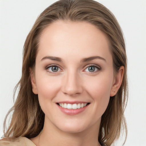 Joyful white young-adult female with long  brown hair and blue eyes